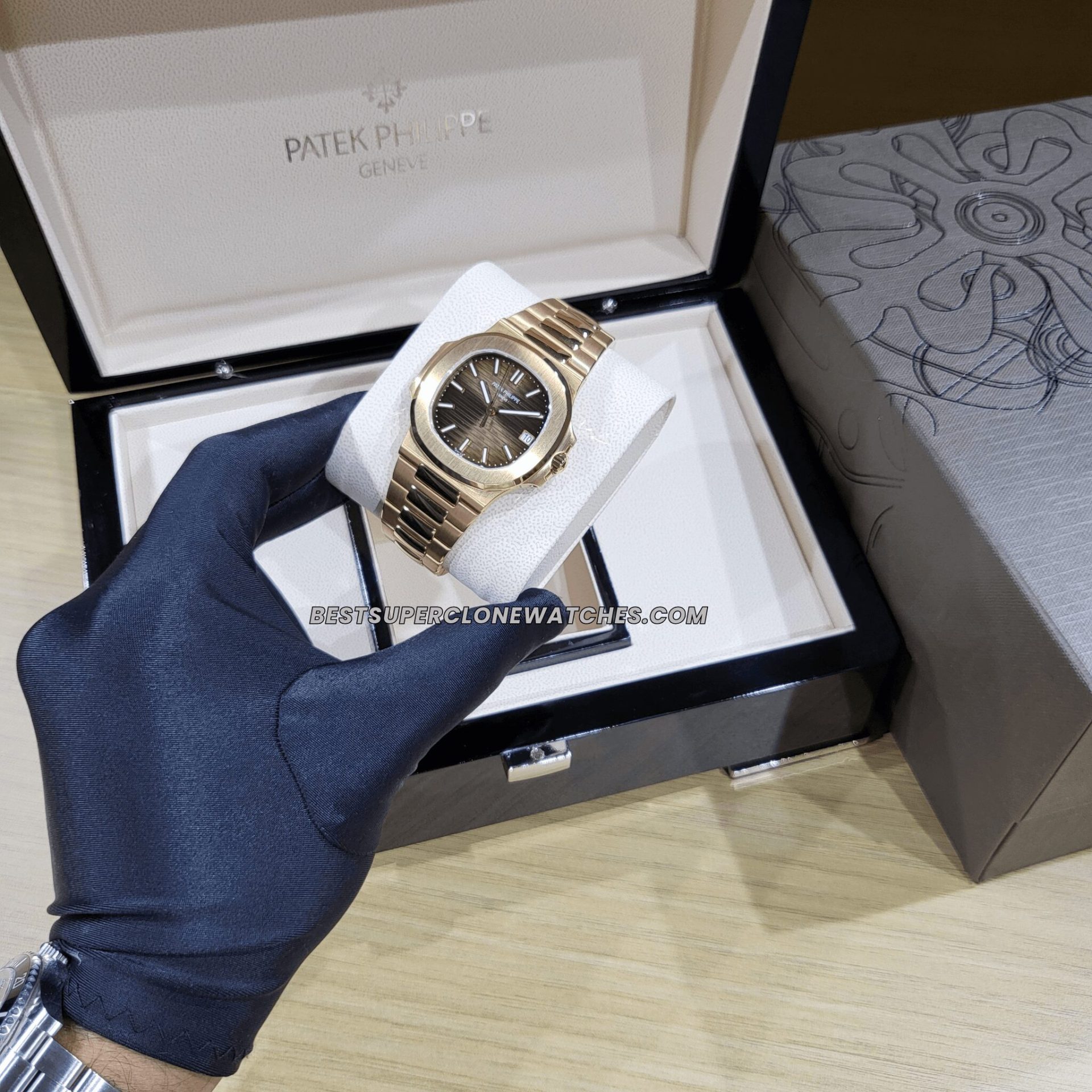 Fake Patek Philippe watch featuring brown horizontal embossed dial and gold hands