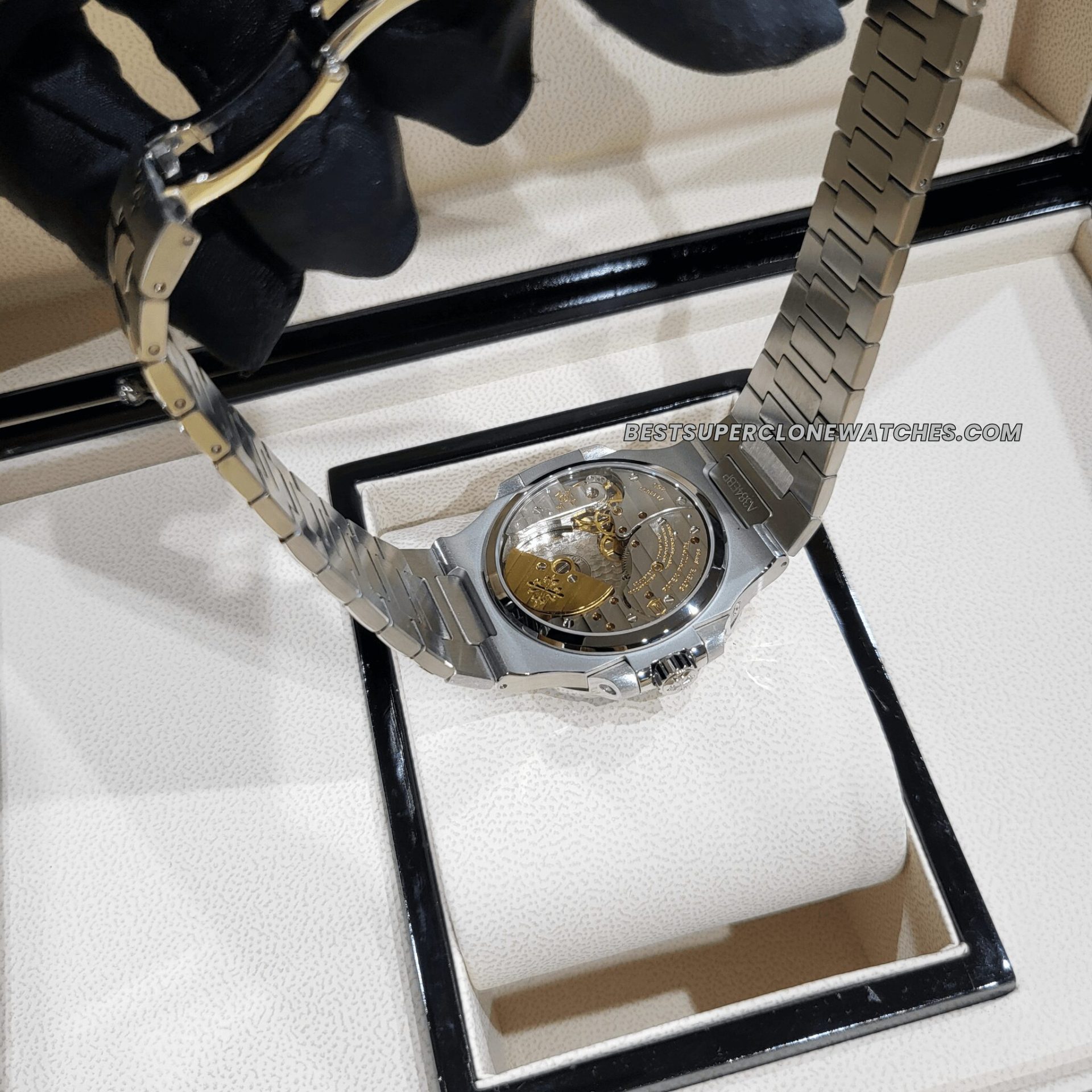 Replica Patek Philippe Nautilus with moon phase, power reserve, and black-blue dial