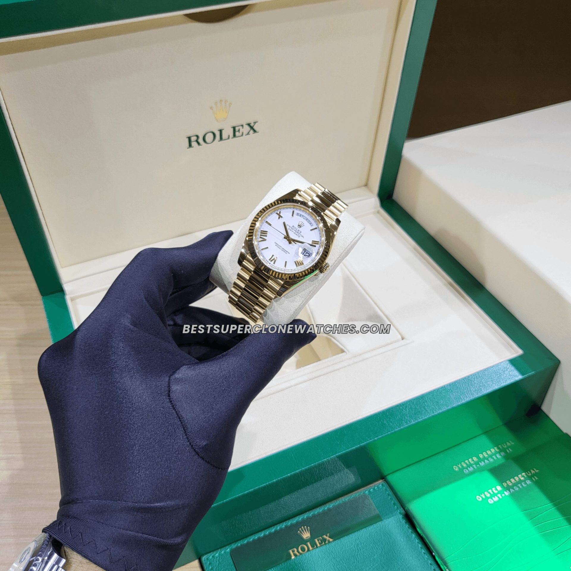 White dial Rolex Day-Date fake watch with roman numerals and gold hands